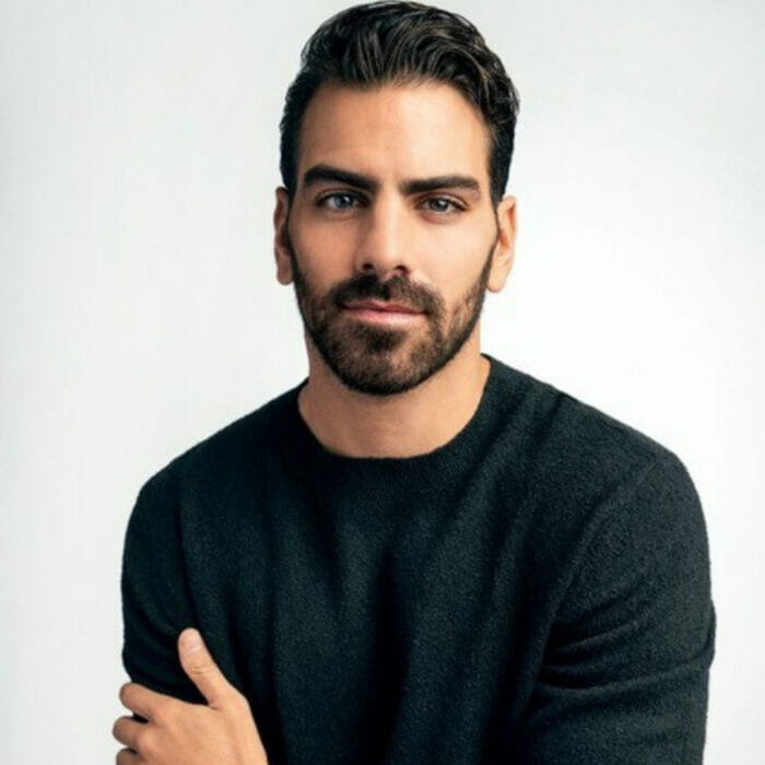 headshot of Nyle DiMarco in green sweater looking to camera